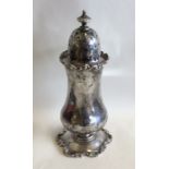 A tall silver sugar caster of shaped form. Birming