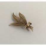 An unusual gold brooch in the form of a flower. Ap