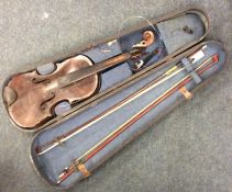 An old cased violin. Labelled inside, 'Josef Guarn
