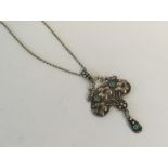 A stylish silver and turquoise pendant with loop t