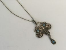 A stylish silver and turquoise pendant with loop t