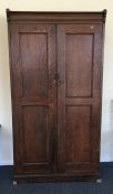 A good oak hall cupboard with panelled sides. Est.