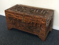 A carved camphor wood trunk of typical design. Est