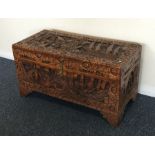 A carved camphor wood trunk of typical design. Est