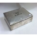 A stylish silver cigarette case of fluted design.