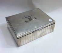 A stylish silver cigarette case of fluted design.