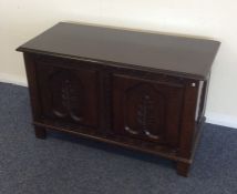 A carved oak hinged top coffer. Est. £30 - £50.