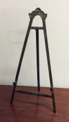 An unusual brass mounted easel with hinged back. E