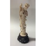 A carved ivory figure of a dancing lady playing a