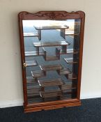 An Eastern hardwood display cabinet with fitted in