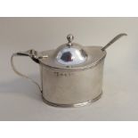 A heavy Georgian silver Adams' style mustard pot w