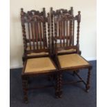 A set of four oak barley twist chairs. Est. £30 -