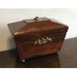 A Georgian mahogany sarcophagus shaped tea caddy o