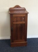 A walnut single door bedside cabinet. Est. £20 - £