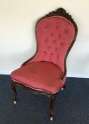 A Victorian mahogany button back chair with scroll