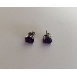 A pair of silver and amethyst ear studs. Approx. 2