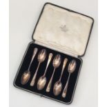 A heavy set of six silver teaspoons contained with