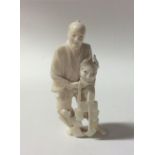 A carved ivory figure of a man in standing positio