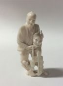 A carved ivory figure of a man in standing positio