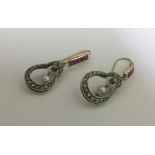 An attractive pair of large ruby and diamond earri