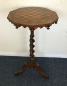 A Victorian games table on barley twist support. E