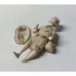A carved ivory figure of a man on oval base. Appro