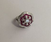 A ruby and diamond Art Deco style cluster ring wit