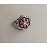 A ruby and diamond Art Deco style cluster ring wit