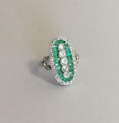 A platinum emerald and diamond cocktail ring in pi