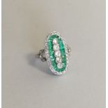 A platinum emerald and diamond cocktail ring in pi