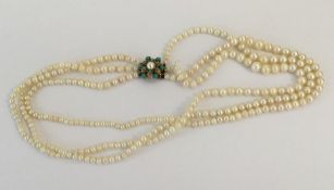 A small gold and pearl mounted triple row necklace