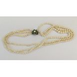 A small gold and pearl mounted triple row necklace