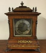 A large oak cased bracket clock with silvered dial
