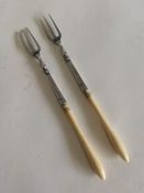 A pair of Antique silver pickle forks of tapering