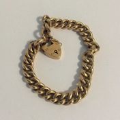 An unusual 15 carat gold curb link bracelet with h
