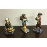 A group of three novelty pottery figures of fisher