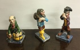 A group of three novelty pottery figures of fisher