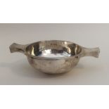 A heavy silver two handled quaich on pedestal foot