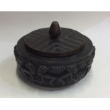 A heavy tribal tobacco pot and cover on circular b