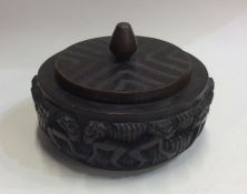 A heavy tribal tobacco pot and cover on circular b