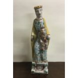 A tall Continental pottery figure of a mother and