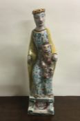 A tall Continental pottery figure of a mother and