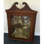 A Georgian mahogany small corner cupboard with str