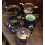 A group of small gilt lustre jugs. Est. £20 - £30.