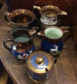 A group of small gilt lustre jugs. Est. £20 - £30.