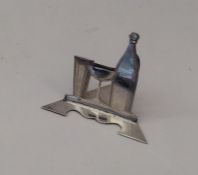 An unusual silver menu holder in the form of a cha