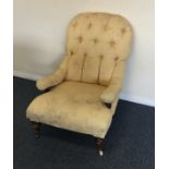 An upholstered button back armchair. Est. £20 - £3