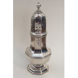 A heavy octagonal silver caster with lift-off cove