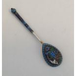 An unusual silver and enamel spoon of tapering for