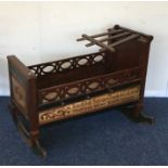 An unusual Continental cot painted with cherubs. E